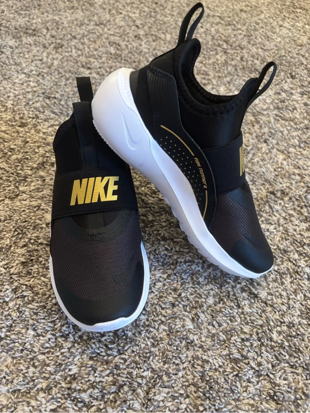 Nike Kids Black Slip-On Sneakers with Gold Logo Strap